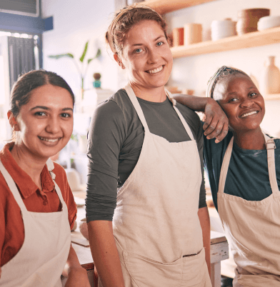 3 employees smile at the camera