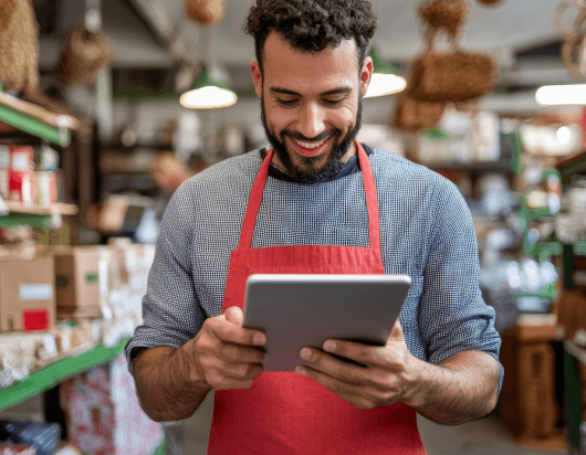 A man using a digital device in a retail store